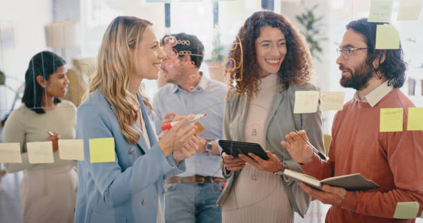 istock Business people, planning and team collaboration with sticky notes in strategy, meeting or project plan at the office. Group of creative employee workers in post it, schedule and tasks at workplace 1437682883