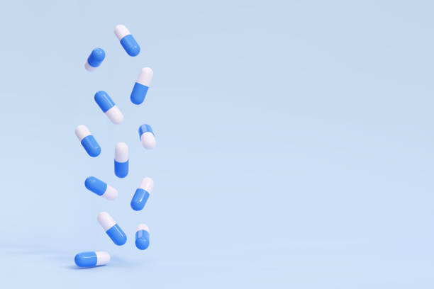 ilustrações, clipart, desenhos animados e ícones de cápsulas de comprimidos em queda 3d em um fundo azul. antibiótico, vitaminas. ilustração vetorial - preparação magistral