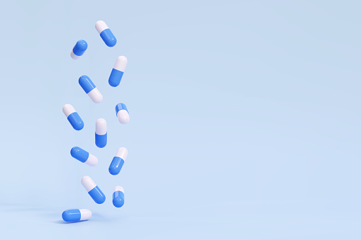 3D falling pills capsules on a blue background. Antibiotic, vitamin drugs. Vector illustration