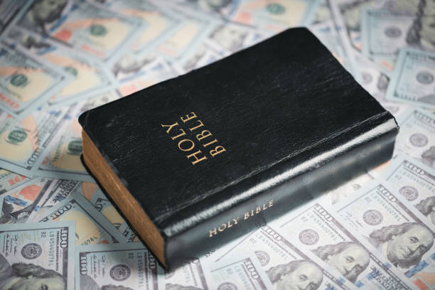 istock One tenth or tithe is basis on which Bible teaches us to give one tenth of first fruit to God. coins with Holy Bible. Biblical concept of Christian offering, generosity, and giving tithes in church. 1437688898