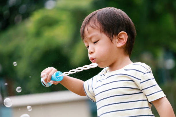 istock Preschoolers boy soap bubble play time at back yard 1437691741