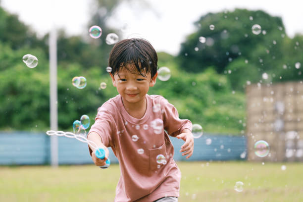 istock Cute little boy soap bubble play time at backyard 1437691814