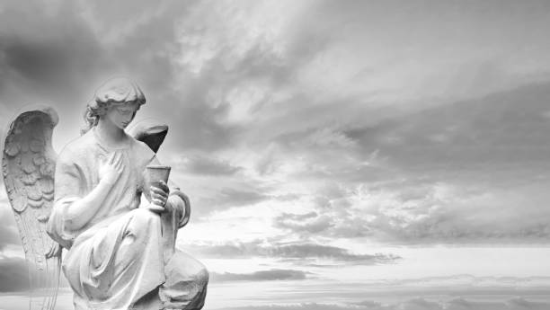 White stone guardian winged angel on sky background