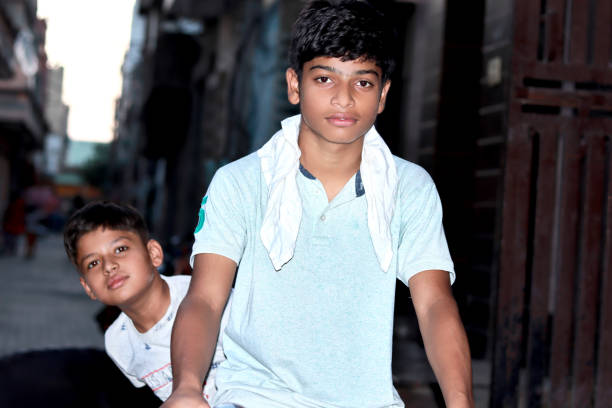 istock Indian teenage boy riding cycle 1437694188