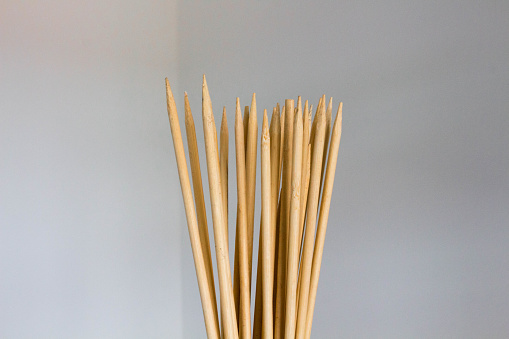 Sharp wooden sticks on a white background.