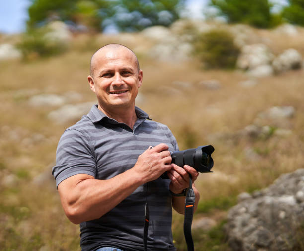 Travel photographer hiking in the forest mountains with his camera stock photo