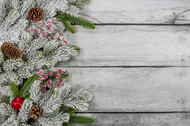 Happy New Year 2023. Beautiful Christmas banner. Fir branches, cones, red berries on a gray wooden background. Celebrating the winter Christmas holidays. The concept of the beginning of the year. Beautiful Christmas banner. Fir branches, cones, red berries on a gray wooden background. hello stock pictures, royalty-free photos & images