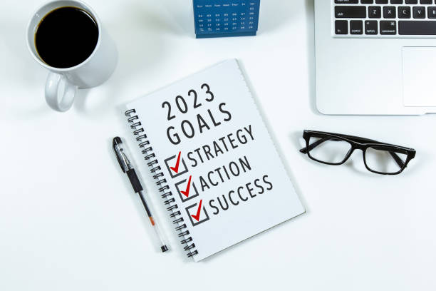 istock 2023 Goal, Strategy, Action, Success checklist text on note pad with laptop, glasses and pen. 1437703561