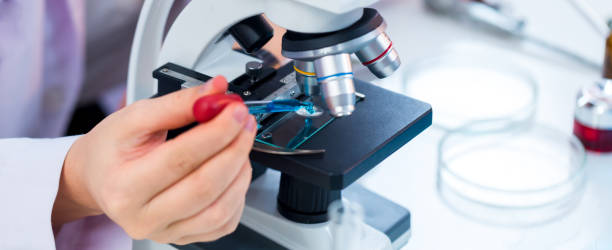 istock Biochemical research scientist working with microscope for coronavirus vaccine development in pharmaceutical research laboratory. Medical Development Laboratory. Medical Science Laboratory. 1437703929