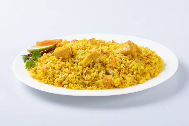istock motton dhum biriyani using jeera rice and spices arranged in earthen ware with raitha and lemon pickle on grey background. 1437704704