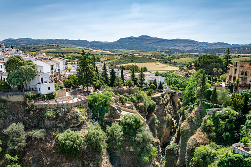 A landscape image of gorge running through the heart of the Pueblo of Ronda and the houses along its peaks