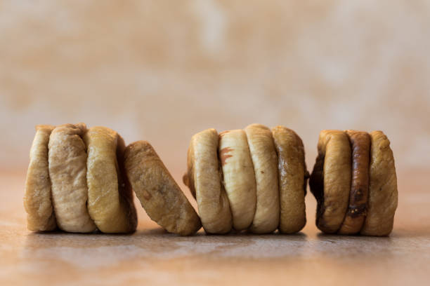 istock Composition Of Whole Dried Figs In A Row 1437705377
