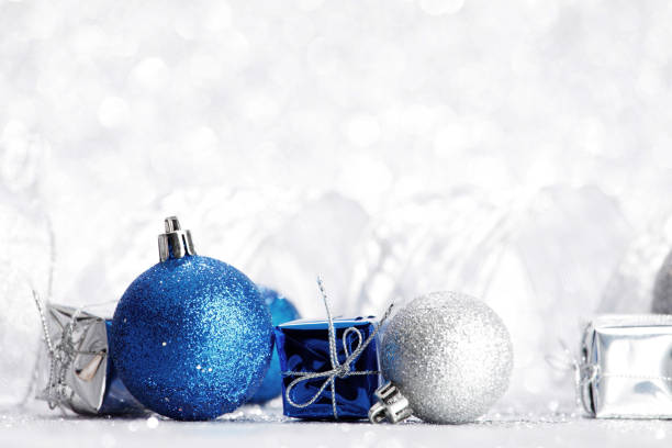 Decorative Christmas ball and gift on abstract glitter silver background