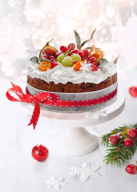 Traditional Christmas fruit cake with white frosting and sugared fruits