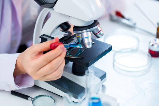 istock Biochemical research scientist working with microscope for coronavirus vaccine development in pharmaceutical research laboratory. Medical Development Laboratory. Medical Science Laboratory. 1437706846