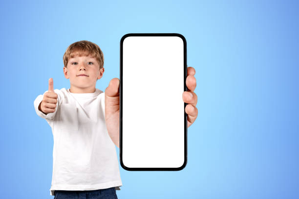 istock Boy wearing casual wear holding smartphone case with copy space 1437707157