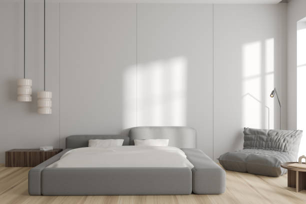 istock Light bedroom interior with bed and armchair with nightstand. Empty wall 1437707161
