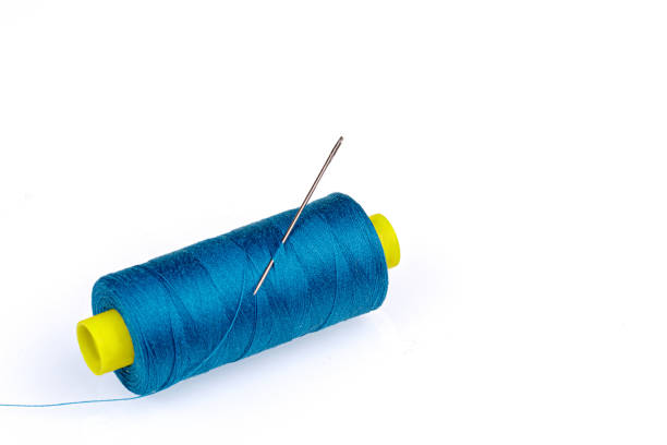 istock Macro skein of blue thread with a needle on a white background 1437708707