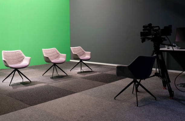 Three empty chairs in a TV studio stock photo