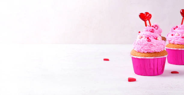 istock Web banner with cupcake with pink icing on white. Mockup with copy space 1437710051