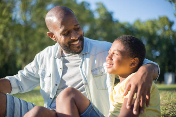 istock Smiling African American dad looking at his happy son 1437710267