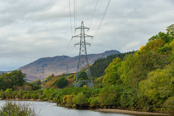tralicci elettrici che corrono accanto al fiume conon a strathconon, una valle remota nelle highlands scozzesi, che forniscono energia ai residenti e alle imprese nella valle. - munros foto e immagini stock