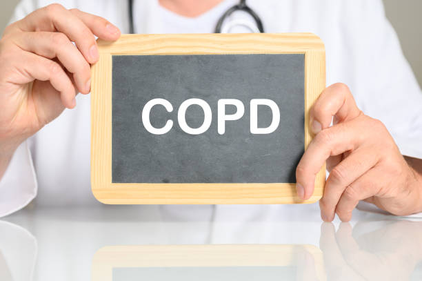 istock Doctor holding a board with COPD word on it 1437713347
