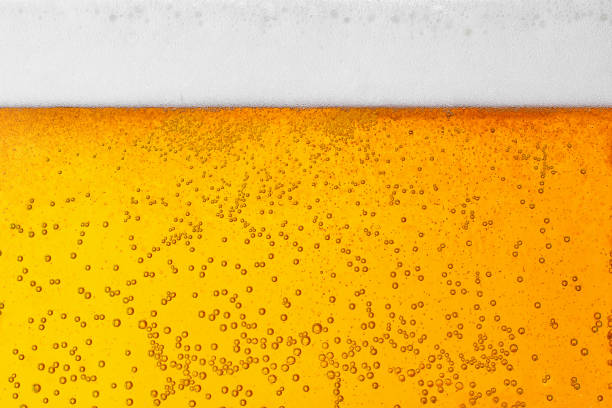 beer background texture with bubbles and foam stock photo