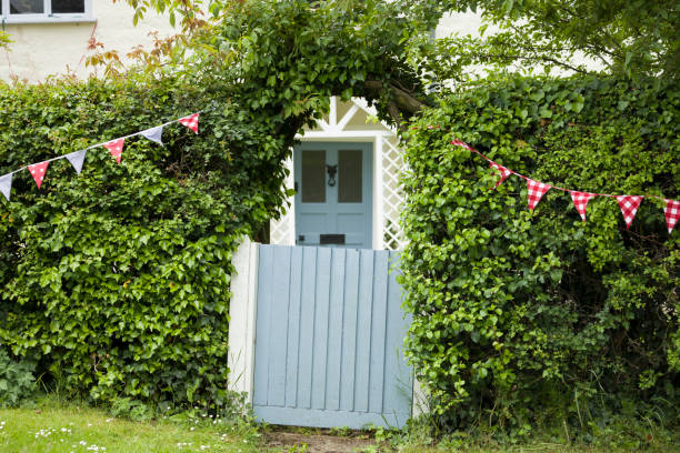 Buckinghamshire, UK - June 03, 2022. House exterior with blue garden gate, front door and hedge