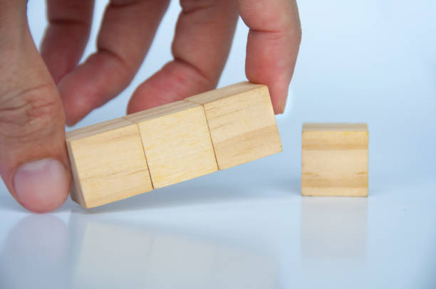 istock Hand holding blank wooden cubes on white background with customizable space for text or ideas. 1437715424