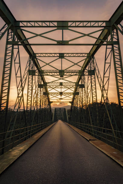 istock Beautiful vertical shot of a bridge at sunset 1437716496