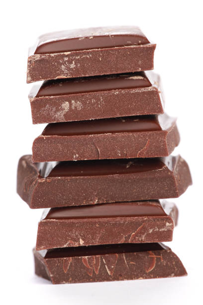 istock Vertical shot of stacked chocolates on a white background 1437716549