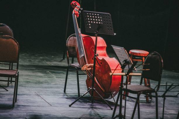 istock Red cello with chairs and music stands on a symphony orchestra stage 1437720733