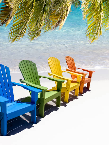 istock Colorful wooden chairs on white sand beach 1437721689