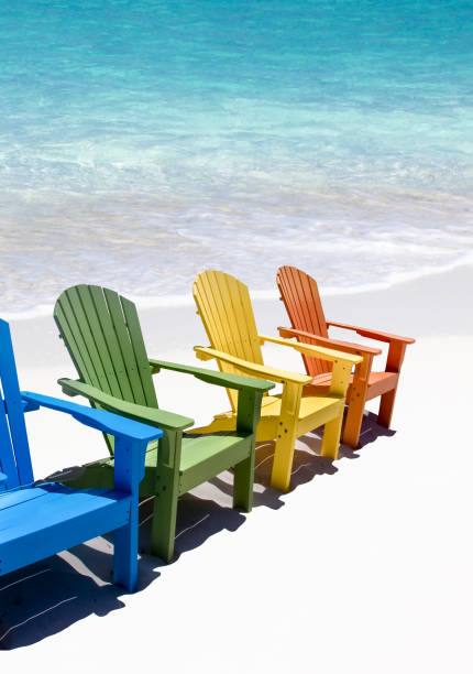 istock Colorful wooden chairs on white sand beach 1437724819