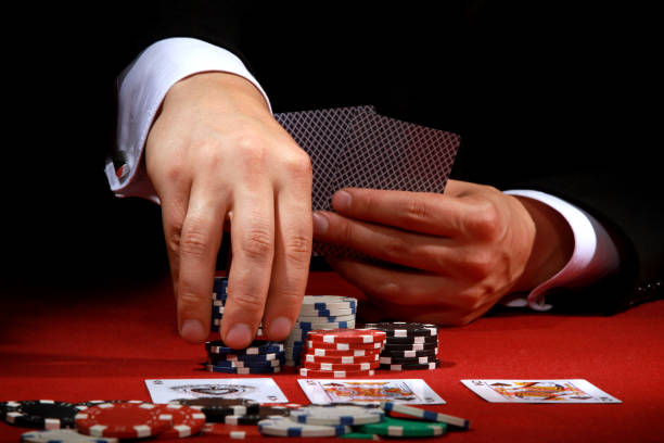 istock Closeup of male hands playing poker 1437728059