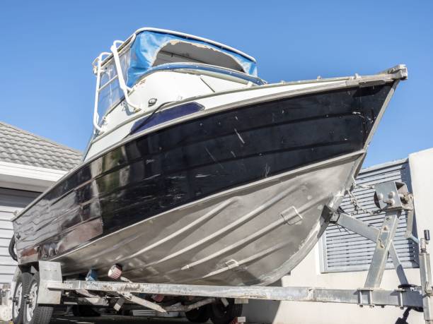 istock aluminum motorboat on trailer parked in driveway. 1437732738