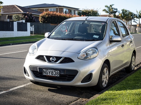 Auckland, New Zealand – August 05, 2022: Silver Nissan Micra, generation IV (K13) facelift 2013-2016. Front left view. Stock photo.