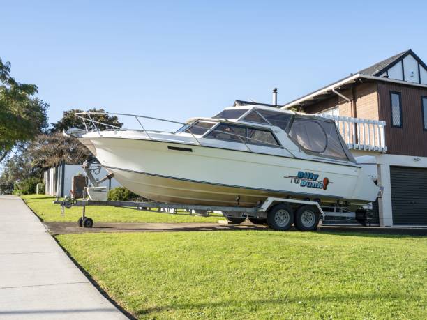 large motorboat on trailer parked in driveway. - runabout imagens e fotografias de stock