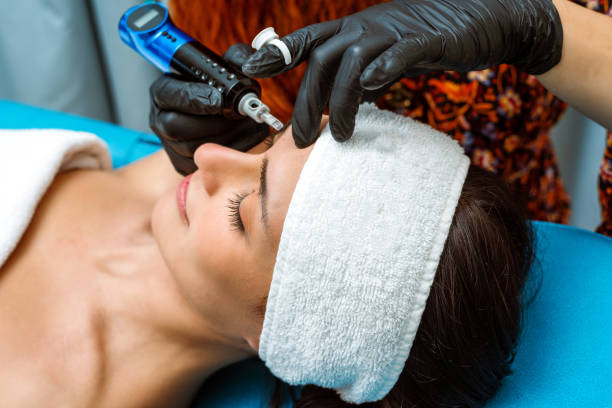 istock Beautician applying permanent make-up to beautiful woman's eyebrows 1437733793