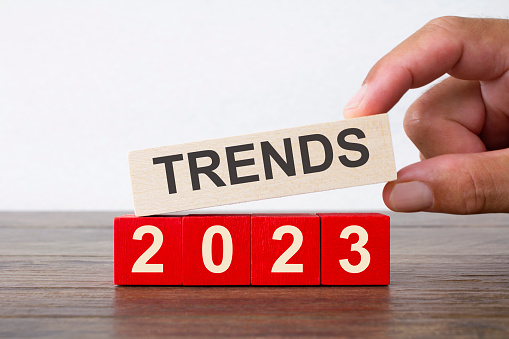 2023 Trends written on wooden blocks, held by a man's hand 
Trends/ New Year concept shot.