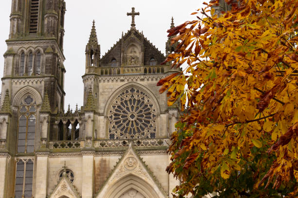 Autumn leaves at the Sanctuaire Notre-Dame de Montligeon, a neo-gothic cathedral stock photo