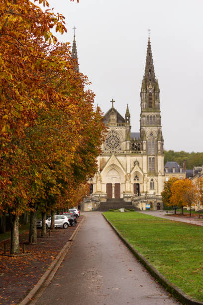 Autumn leaves along the boulevard de la Basilique at Sanctuaire Notre-Dame de Montligeon stock photo