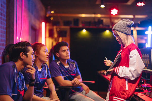 istock Asian female coach explaining strategy to gamers 1437737802