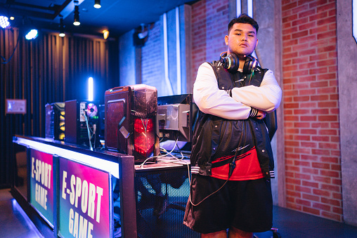 Portrait of Asian gamer guy at an esports training base while preparing for a major tournament