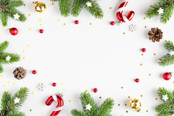 istock Christmas composition. Frame made of fir tree branches, holiday decorations on white background. Flat lay 1437739679