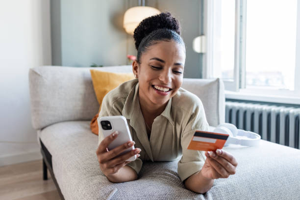 istock Young woman using smart phone to shop online 1437740086