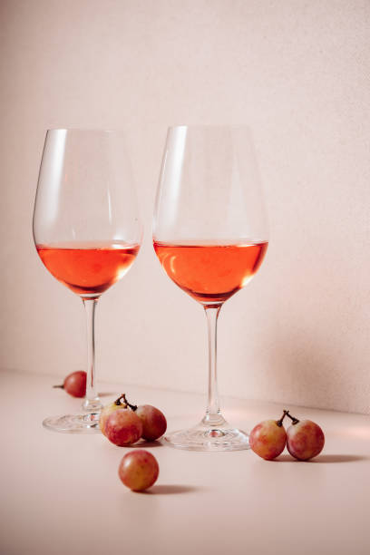 istock Two glasses of rose wine and red grapes. 1437741128