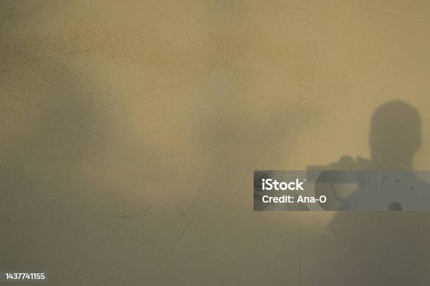 Shadows In A Wall Reflection Silhouette Of The Photographer Taking Photo Of Himself Silhouette Of Photographer Taking A Photo Stock Photo - Download Image Now