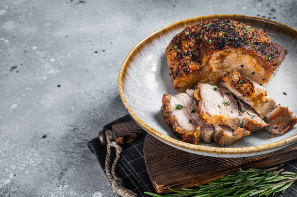 istock Filipino marinated pork belly with crust in a plate. Gray background. Top view. Copy space 1437741224